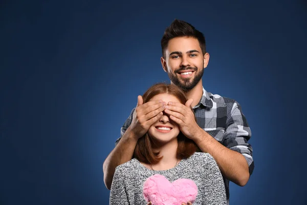Young Man Covering His Girlfriend Eyes Color Background Celebration Saint — Stock Photo, Image
