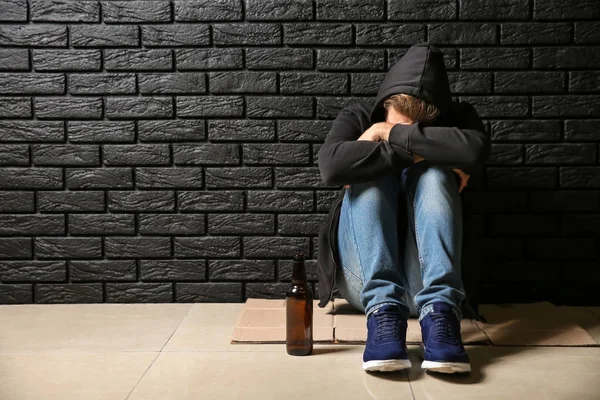 Giovane Depresso Con Bottiglia Birra Seduto Sul Pavimento Vicino Muro — Foto Stock