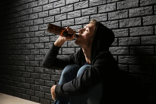 Depressed Young Man Drinking Beer Black Brick Wall Alcoholism Concept — Stock Photo, Image