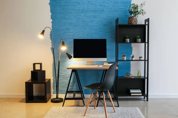 Stylish workplace with modern computer in room