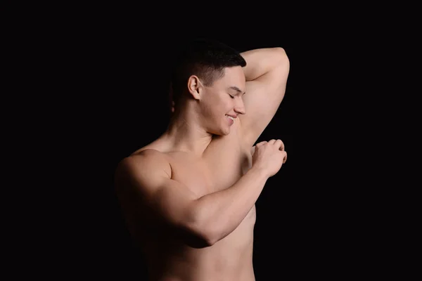 Young Man Using Deodorant Dark Background — Stock Photo, Image