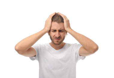 Young man suffering from headache on white background clipart