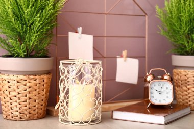 Limon servi ağaçları, mum, kitap ve masada saat