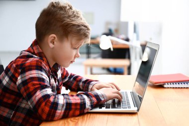 Sevimli çocuk evde laptop bilgisayar oyunu oynamak