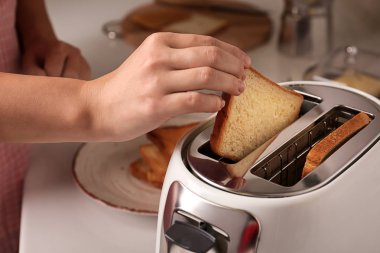 Kadın mutfakta kahvaltı için tost hazırlanıyor