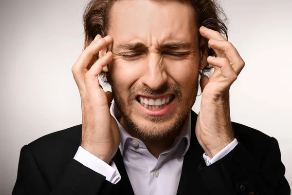 Young Businessman Suffering Headache Light Background — Stock Photo, Image