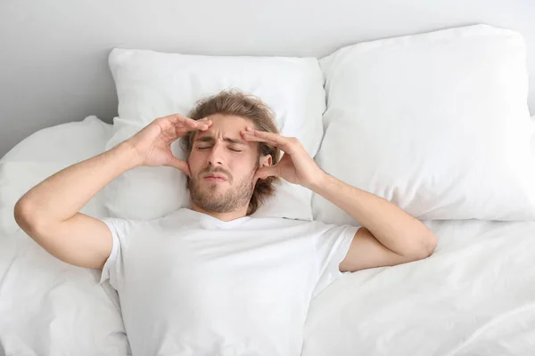 Young Man Suffering Headache Bedroom — Stock Photo, Image