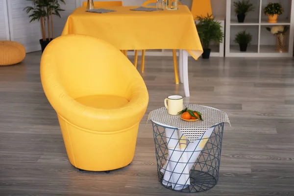 Stylish bright armchair in interior of room