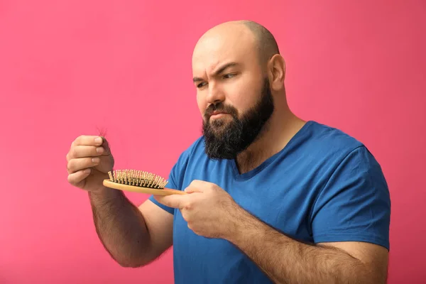 Man with hair loss problem on color background