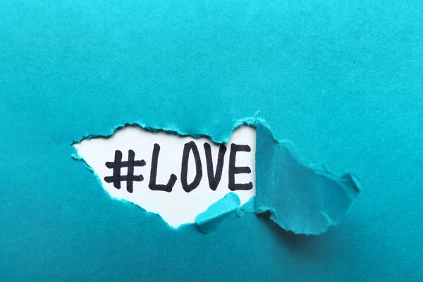 Hashtag LOVE under torn color paper
