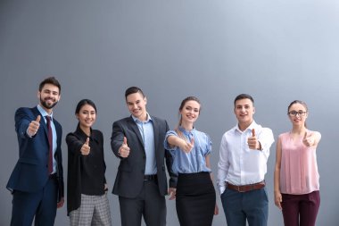 Gençler gösteren başparmak-up jest gri arka plan üzerinde