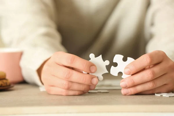 Woman Assembling Puzzle Table Closeup — Stock Photo, Image