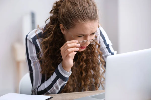 Businesswoman with bad sight working in office