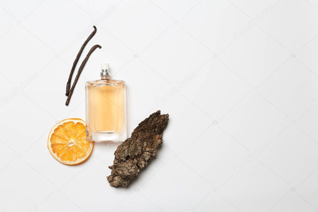 Composition with vanilla perfume on white background