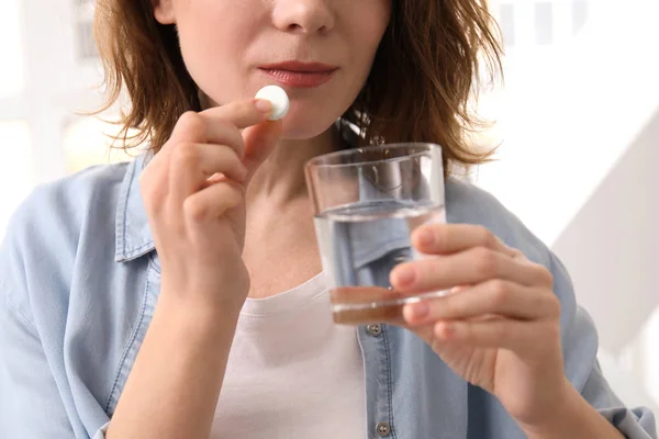 Young Woman Taking Pill Indoors — Stock Photo, Image