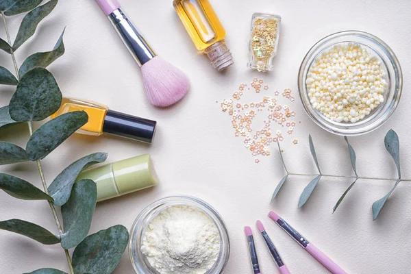 Composition with cosmetic products on light background