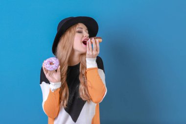 Lezzetli donuts renk arka plan üzerinde olan güzel kadın