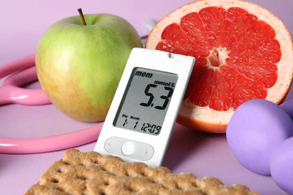 Digital glucometer with healthy food on color background. Diabetes diet