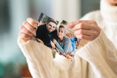 Woman tearing up photo of happy couple, closeup. Concept of divorce clipart