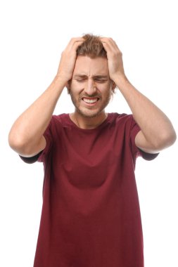 Beyaz arka planda baş ağrısı çeken genç bir adam.