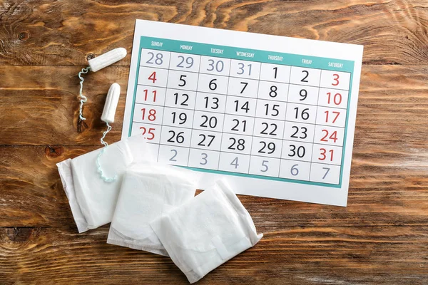 Menstrual Calendar Feminine Products Wooden Background — Stock Photo, Image