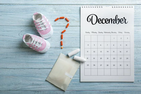 Menstrual Calendar Feminine Products Pills Baby Shoes Wooden Table — Stock Photo, Image