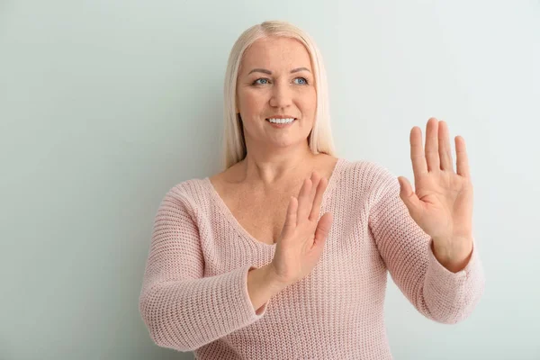 Beautiful Mature Woman Refusing Something Light Background — Stock Photo, Image