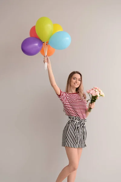 Beautiful Young Woman Bouquet Flowers Bright Balloons Grey Background — Stock Photo, Image