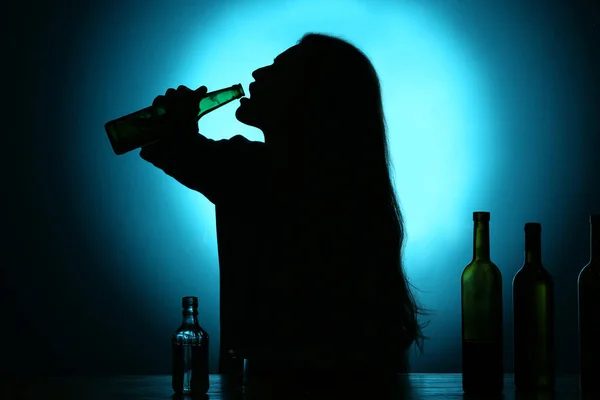 Silhouette Donna Che Beve Alcol Tavola Contro Sfondo Scuro — Foto Stock
