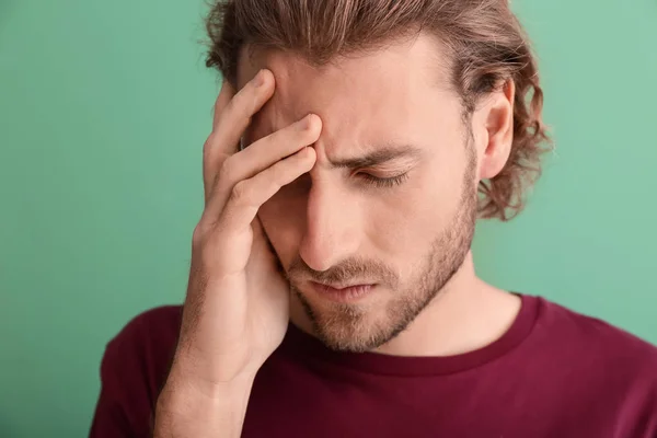 Young Man Suffering Headache Color Background — Stock Photo, Image