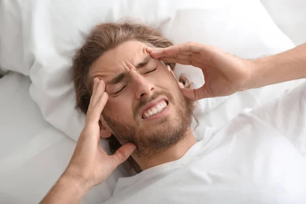 Young Man Suffering Headache Bedroom — Stock Photo, Image