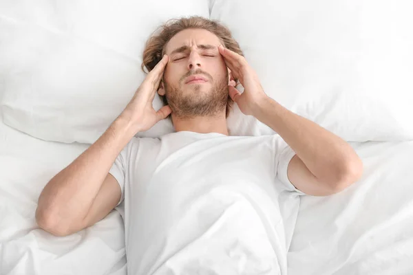 Young Man Suffering Headache Bedroom — Stock Photo, Image