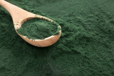 Tahta kaşık spirulina tozu üzerinde