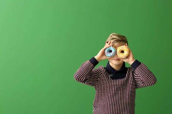 Mignon Petit Garçon Avec Des Beignets Sur Fond Couleur — Photo