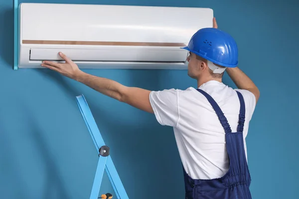 Male Technician Repairing Air Conditioner Indoors — Stock Photo, Image