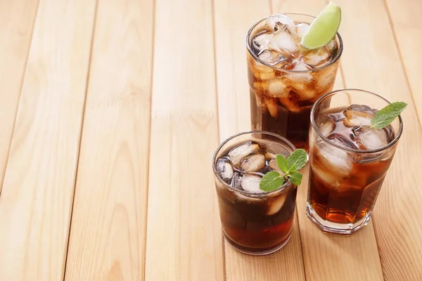 Ahşap masa üzerinde lezzetli soğuk kola bardak