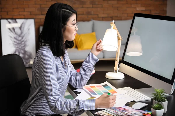 Female designer working on new logo in office