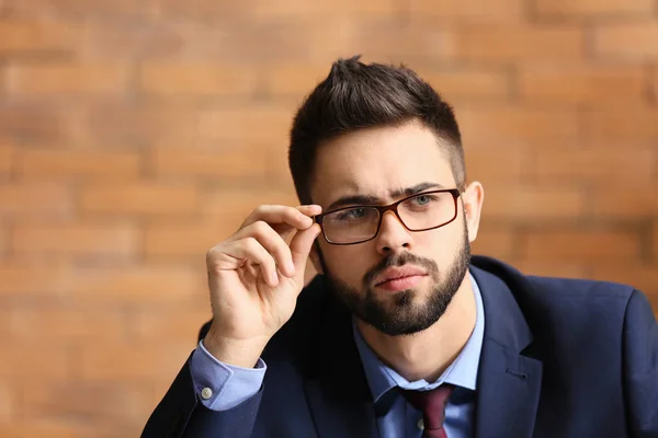 Portrait of young man with bad sight in office