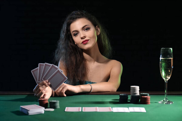 Beautiful female player at table in casino