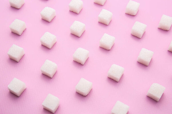 Many sugar cubes on color background