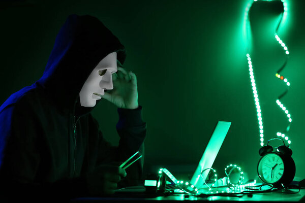 Professional hacker working in dark room