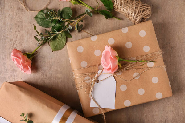 Festive gift boxes and flowers on table