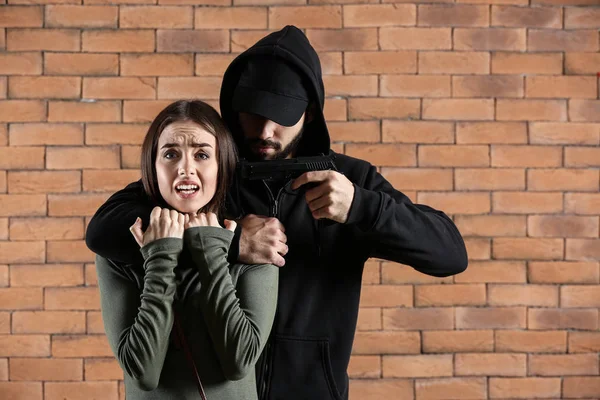 Male Criminal Scared Female Victim Brick Background — Stock Photo, Image