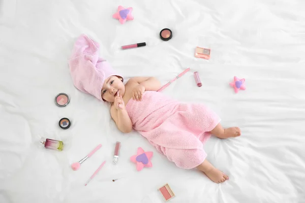 Niedliche Baby Mädchen Mit Kosmetik Auf Dem Bett Liegend — Stockfoto