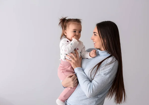 Young Mother Her Cute Little Daughter Light Background — Stock Photo, Image