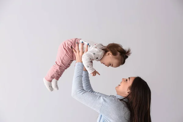 Young Mother Her Cute Little Daughter Light Background — Stock Photo, Image