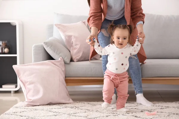 Young Woman Teaching Her Cute Little Daughter Walk Home — Stock Photo, Image