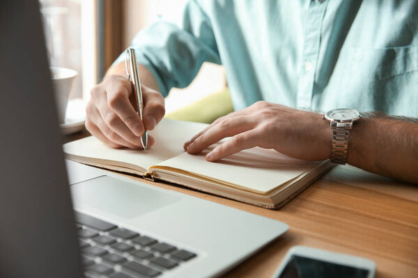 Young businessman working in cafe