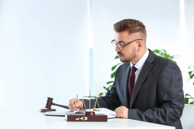 Handsome male lawyer working in office clipart