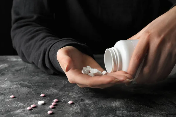 Woman going to take many pills, closeup. Suicide concept